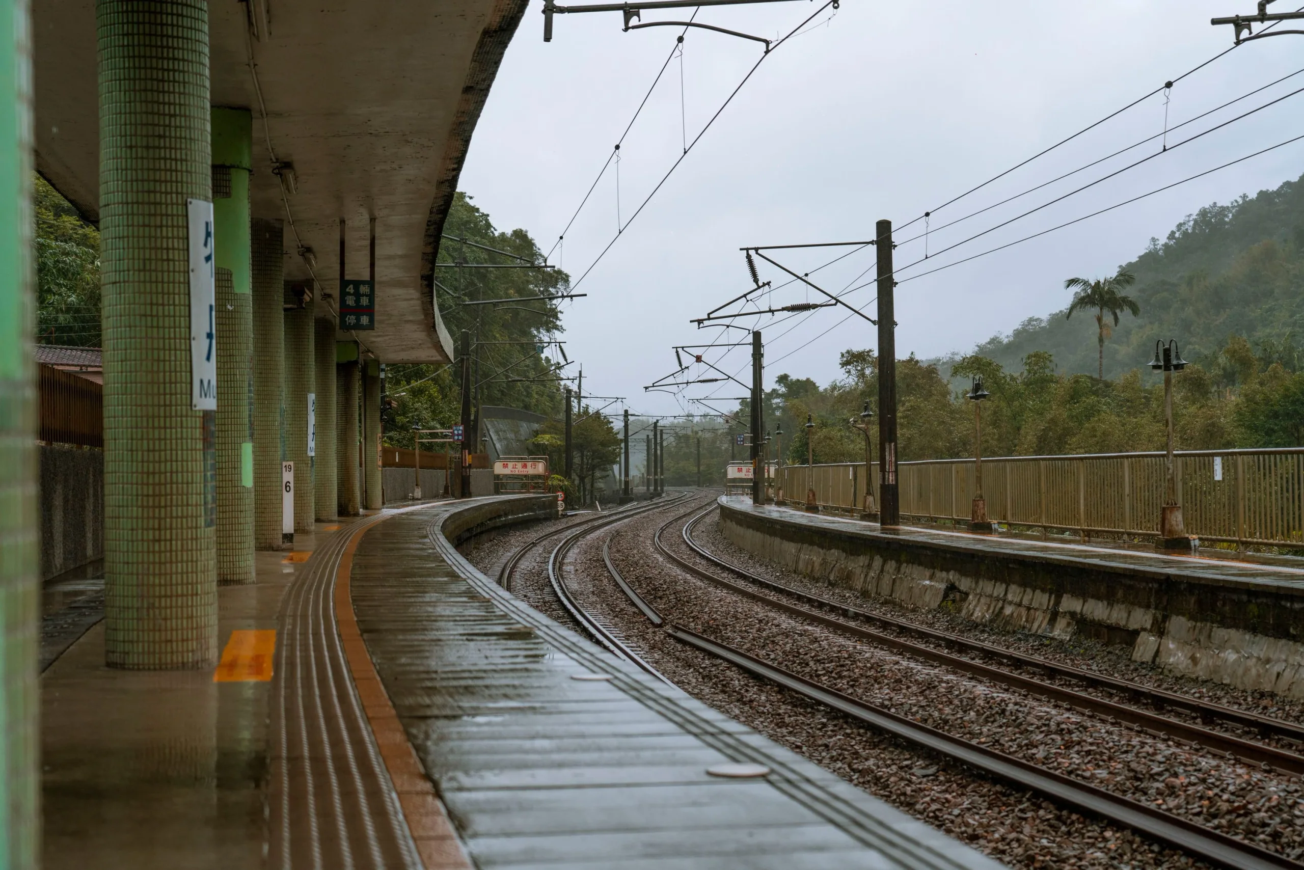 雨天濕潤的鐵路月台與軌道